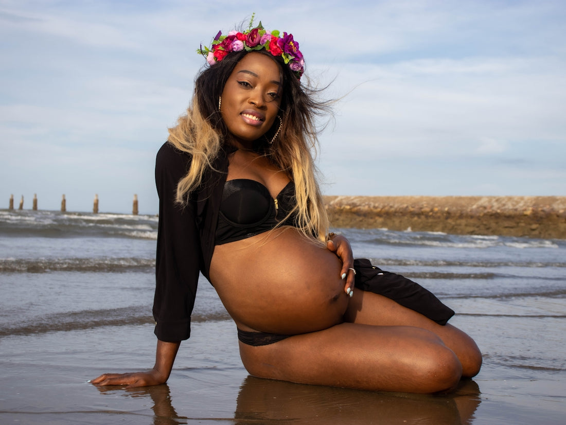 woman in black bikini sitting on beach during daytime
