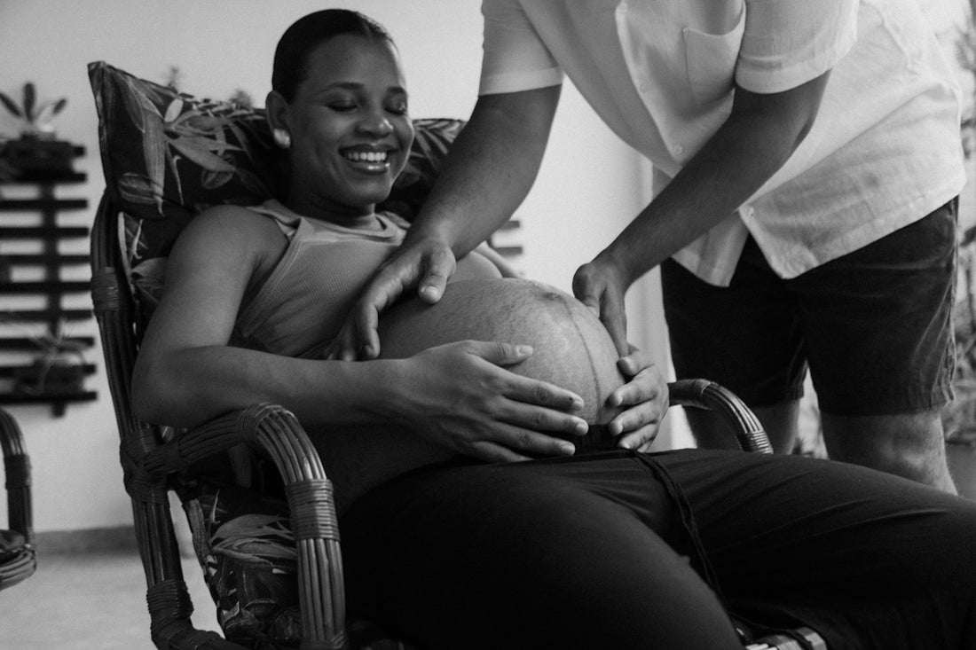 a woman sitting in a chair holding a ball